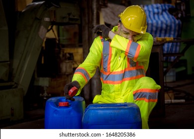 A Engineer industry wearing safety uniform ,black gloves ,gas mask feel suffocate when under checking chemical tank in industry factory work.