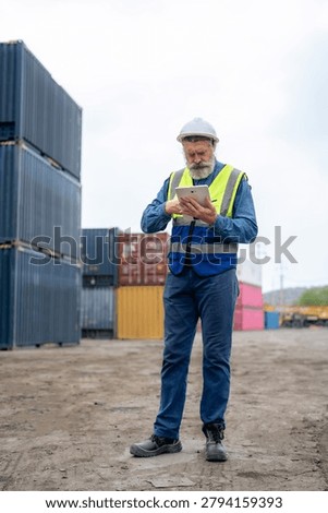 Engineer inspecting cargo containers at warehouse yard. Shipping, freight transport.