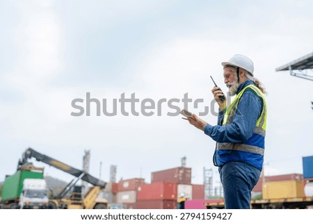 Engineer inspecting cargo containers at warehouse yard. Shipping, freight transport.