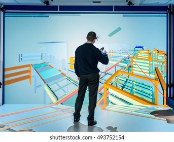 Engineer inspecting factory layout in 3D in virtual reality suite