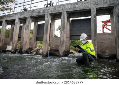 Engineer Inspecting Water Gate Structure for Irrigation and Flood Control Infrastructure