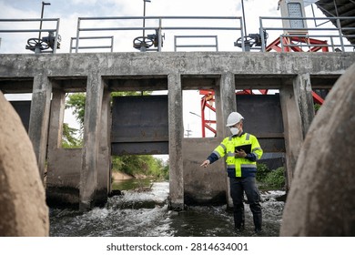 Engineer Inspecting Water Gate Structure for Irrigation and Flood Control Infrastructure