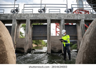 Engineer Inspecting Water Gate Structure for Irrigation and Flood Control Infrastructure
