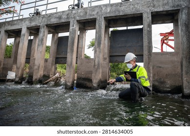Engineer Inspecting Water Gate Structure for Irrigation and Flood Control Infrastructure