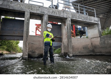 Engineer Inspecting Water Gate Structure for Irrigation and Flood Control Infrastructure