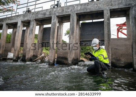 Engineer Inspecting Water Gate Structure for Irrigation and Flood Control Infrastructure