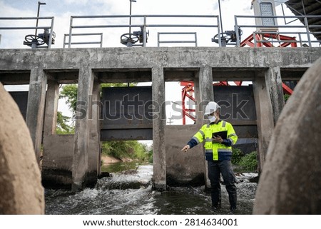 Engineer Inspecting Water Gate Structure for Irrigation and Flood Control Infrastructure