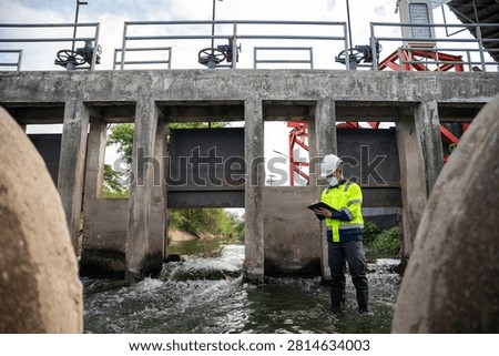 Engineer Inspecting Water Gate Structure for Irrigation and Flood Control Infrastructure
