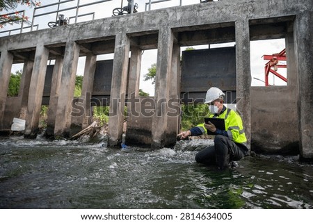 Engineer Inspecting Water Gate Structure for Irrigation and Flood Control Infrastructure