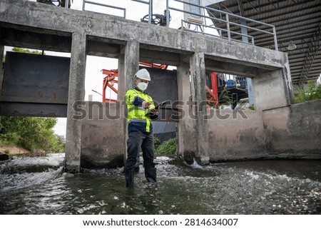 Engineer Inspecting Water Gate Structure for Irrigation and Flood Control Infrastructure