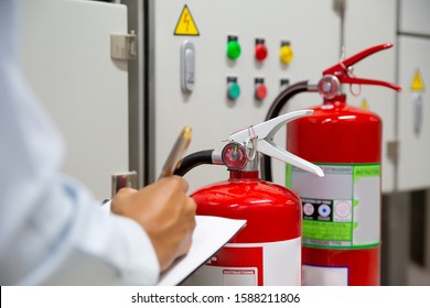 Engineer Are Inspection Fire Extinguisher In Fire Control Room For Prevention, Rescue And Safety Concept.