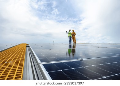 Engineer Inspector Quality in Solar Roof Panel Installation with Technician, Quality Control in Work of Sustainable Photovoltaic Installation on Factory Roof Buildings. - Shutterstock ID 2333017397