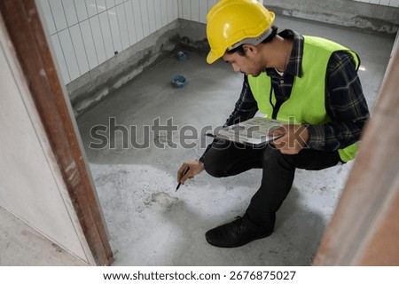 Engineer or inspector using blueprint check sheet examining cracked concrete floor during house construction. Quality control, building inspection, structural defect, real estate maintenance concept.