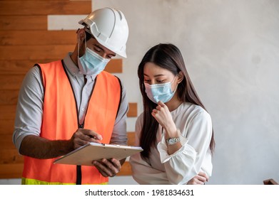 Engineer or interior architect designer, technician and house owner wearing the face mask prevent virus discussing about home decoration maintenance, repair or design renovation. New normal business. - Powered by Shutterstock