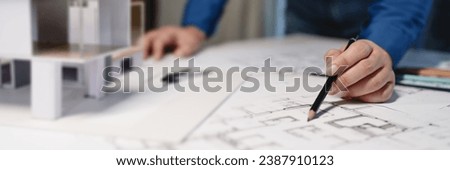 Engineer or interior Architects designer construction plans on blueprint