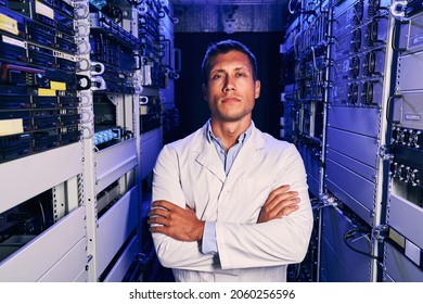 IT Engineer In Lab Coat Standing In Server Room