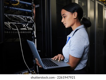 Engineer, laptop database and woman in server room for software update or maintenance at night. Cybersecurity coder, cloud computing and female programmer with computer for networking in data center. - Shutterstock ID 2261947921
