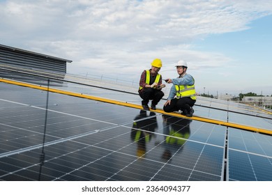 engineer maintenance solar panel, engineering service and check solar cell installing rooftop. Photovoltaic installing buildings in factory. engineer, electrician check system solar energy on rooftop.