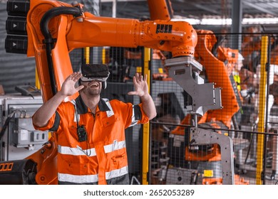 Engineer male using VR virtual reality goggle headset device to control operate robot arm in modern technology industry