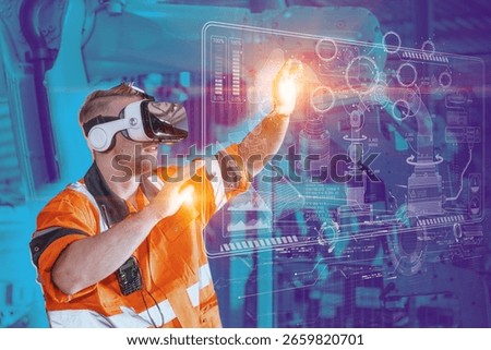 Engineer male using VR virtual reality goggle headset device to control operate robot arm in modern technology industry