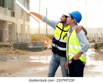 Engineer Man And Architect, Contractor Wear Safety Helmets Discuss Housing Development Project At Construction Site As On Blueprint. Contractor Manager Inspecting House Building Estate Infrastructure