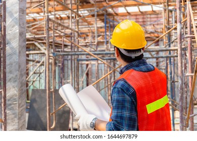 Engineer man checking and planning project at construction site, Man holding blueprint selective focus on paper - Shutterstock ID 1644697879