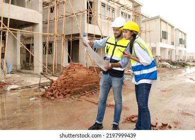 Engineer Man And Female Architect Wear Safety Helmets To Discuss Housing Development Project At Construction Site As On Blueprint. Contractor Manager Inspecting House Building Estate Infrastructure