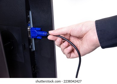 IT engineer Man hand inserts cable into monitor. Man hand connecting the DVI cable for monitor to computer PC. VGA DVI DisplayPort and power cable. close up in the hands of an . copy space.