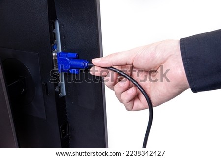 IT engineer Man hand inserts cable into monitor. Man hand connecting the DVI cable for monitor to computer PC. VGA DVI DisplayPort and power cable. close up in the hands of an . copy space.