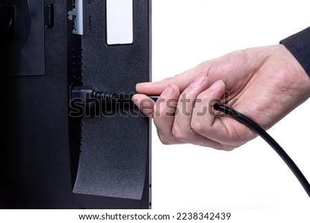IT engineer Man hand inserts cable into monitor. Man hand connecting the DVI cable for monitor to computer PC. VGA DVI DisplayPort and power cable. close up in the hands of an . copy space.