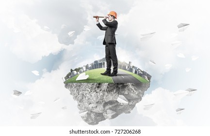 Engineer Man Standing On Green Floating Island In Blue Sky