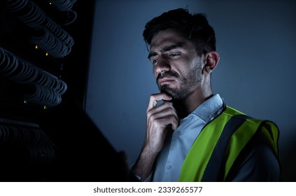 Engineer man, thinking and dark server room for information technology, maintenance and check app on tablet. IT technician, cyber security and ideas for inspection, analysis and check at data center