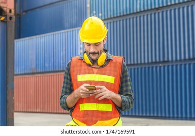 Engineer Man Uses Mobile Phone, Industrial Worker Using Mobile Smartphone In Industry Containers Cargo