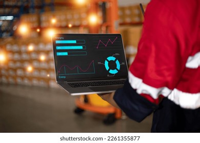 Engineer man using a laptop computer with Dashboard, Analysis charts display. Employee browsing internet, using trackpad in an online store warehouse storeroom with parcels. Infographic graph.  - Powered by Shutterstock