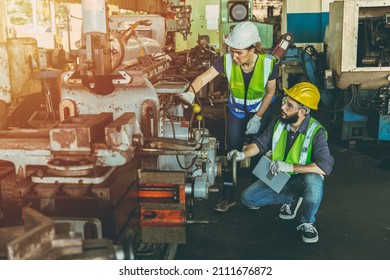 Engineer man and woman team work working together service fix check machine in factory - Powered by Shutterstock