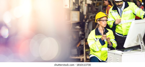 Engineer Man And Woman Worker Working On Personal Computer In Heavy Industry Manufacturing Facility. Professional Engineering Team.