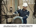Engineer man worker control and checking machine in warehouse for production supply