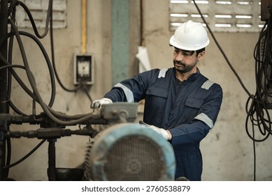 Engineer man worker control and checking machine in warehouse for production supply