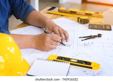 Engineer man working with drawings inspection in workplace in office .Engineering tools and construction concept. architect and Business concept.