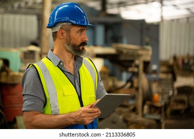 Engineer manager factory using tablet for check his job in production line. Businessman control and plan his occupation.Hard working career. - Shutterstock ID 2113336805