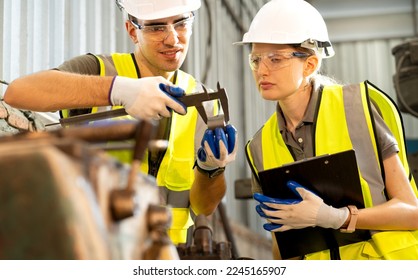 Engineer manager and female technician used equipment tools in metalwork. Vernier calipers are widely used in scientific laboratories and in manufacturing for quality control precision measurements. - Powered by Shutterstock