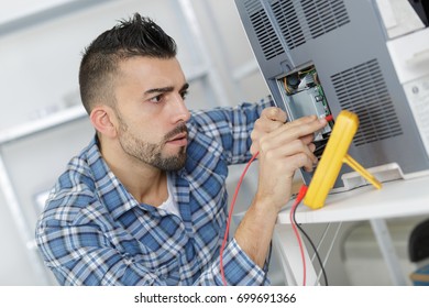 engineer measuring multimeter panel board