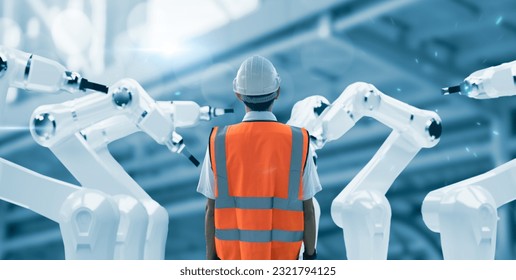 Engineer mechanic worker wearing safety gear operating on AI robot mechanical hand artificial intelligence technology, working in factory operation control maintenance checkup monitoring efficiency - Powered by Shutterstock