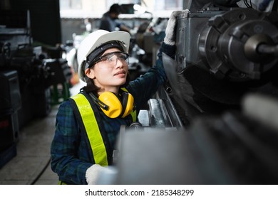 Engineer mechanical women in safety suits using digital tablet working with grinding machine metal in the factory, female worker maintenance and check machinery, manufacturing steel industry. - Powered by Shutterstock