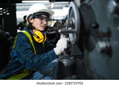 Engineer mechanical women in safety suits using digital tablet working with grinding machine metal in the factory, female worker maintenance and check machinery, manufacturing steel industry. - Powered by Shutterstock