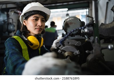 Engineer mechanical women in safety suits using digital tablet working with grinding machine metal in the factory, female worker maintenance and check machinery, manufacturing steel industry. - Powered by Shutterstock