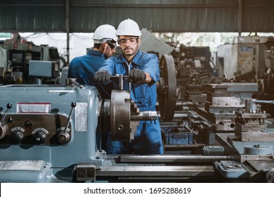 Engineer men wearing uniform safety workers perform maintenance in factory working machine lathe metal. - Powered by Shutterstock