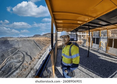 engineer miner worker, at the diamond open pit mine, overlooking the extraction process at the plant in the diamond industry at sunset supervising workers at Jwaneng diamond mine in Botswana