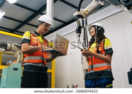 Engineer in a modern lab working with robotics and artificial intelligence technology. Hands-on STEM education with teamwork, coding, machine learning, and industrial training for the future workforce