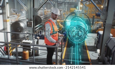 An engineer on a high-tech robotic line for the production of aerospace engines controls information using a modern innovative graphical interface.